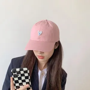 Casual pink baseball cap with blue heart embroidery on 6-panel cotton twill structure