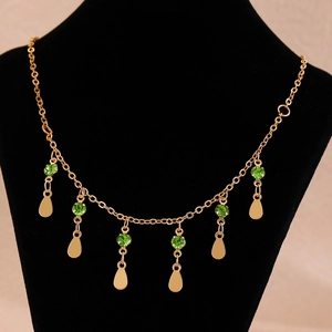 Elegant gold double-layered necklace with green faceted gems and teardrop metal pendants