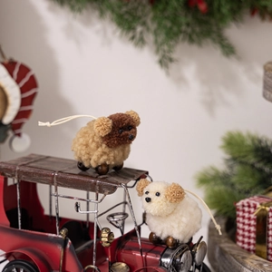 Close-up of plush sheep Christmas tree ornaments with wooden bead legs on a vintage red car