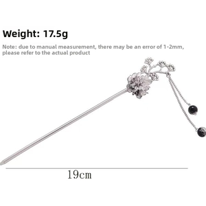 Detailed view of silver ink-style flower hairpin with dangling tassels and measurements