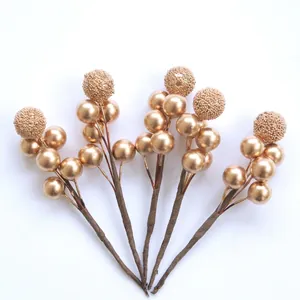 Five gold artificial berry stems with glossy and glitter finish for Christmas decoration