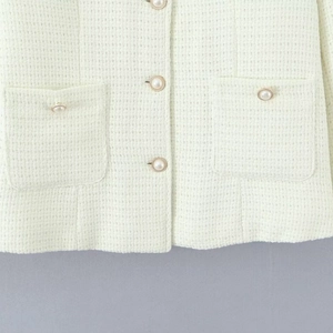 Women's cream white tweed jacket with gold-rimmed pearl buttons and woven texture