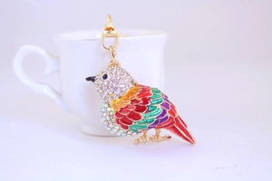 Detail of colorful enamel kingfisher bird keychain with sparkling crystal rhinestones