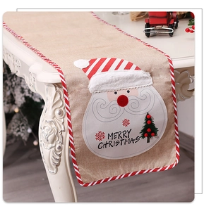 Detail of Christmas burlap table runner featuring 3D Santa applique and Merry Christmas text