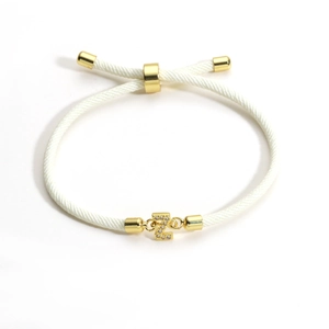 Detail of adjustable white braided bracelet with gold Z initial pendant and micro zircons