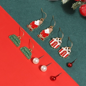Detail view of a 5-pair Christmas earring set with Santa, gift box, and pearl studs