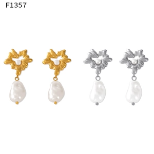 Macro view of Hepburn style heart earrings with baroque shell pearl pendants in gold and silver