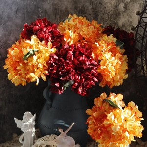 Artistic close-up of dark red and orange vintage hydrangeas in a ceramic pot vase