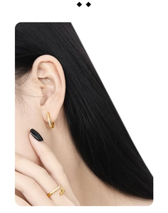 Detail of gold S925 silver earring and ring with micro pavé cubic zirconia inlay
