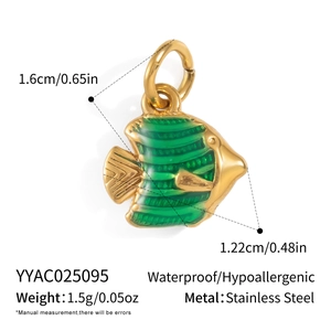 Detail view of a 1.6cm gold fish pendant made of stainless steel with green enamel stripes