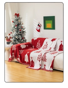 Close-up of red and white Christmas throw blanket with knit fringe and tree patterns