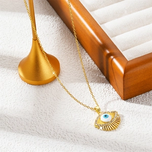 Golden Evil Eye necklace featuring a radiant sunburst pendant with blue eye design