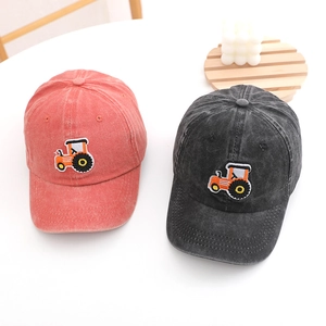 Close-up of tractor embroidery detail on washed cotton baseball caps for kids