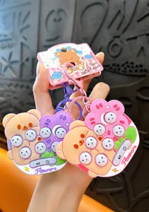 Detail of cute bear and flower whack-a-mole game keychains with smooth edges.