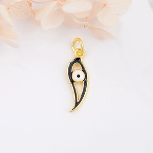 Gold plated evil eye pendant necklace with black enamel inlay on a white surface
