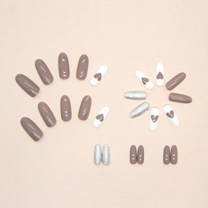 Medium-length almond press-on nails with purple gloss, brown hearts and silver glitter