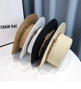 Detail view of flat top straw hats in four colors with leather bands and gold buckles