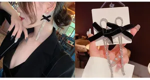 Detail view of long tassel earrings with black velvet bows and sparkling rhinestone chains