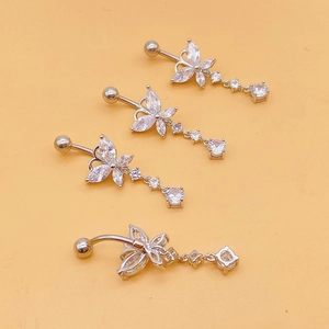 Set of four silver butterfly belly rings with zircon tassels on orange background