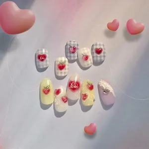 Handmade press-on nails set with 3D peach and heart designs in pastel blue and lavender