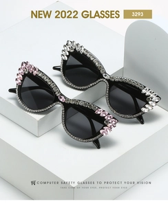 Detail of cat-eye frames with rhinestone accents and pink gemstones on white pedestals