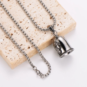 Native American chief bell pendant necklace in stainless steel on stone display