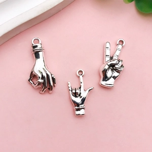 Dettaglio dei ciondoli a forma di gesto in argento vintage per creazione gioielli DIY