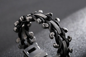 Macro shot of woven leather texture and polished stainless steel clasp on retro bracelet
