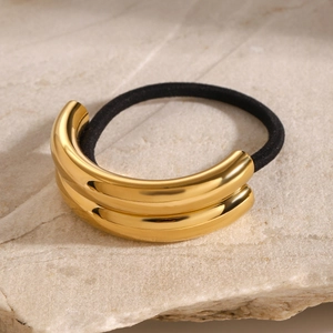 Detail of golden double-layered metal ornament on high-elastic black ponytail hair tie