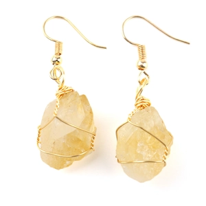 Close-up of handmade gold wire-wrapped raw yellow crystal agate drop earrings