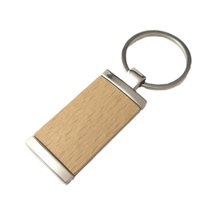 Rectangle beech wood keychain with polished metal frame and ring on white background