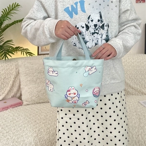 Detail of light blue canvas tote bag with cute rabbit print and SO CUTE lettering