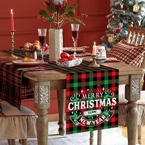 Red and green plaid Christmas table runner with Merry Christmas text on a wooden table