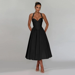 Close-up of elegant black halter neck midi dress featuring a sweetheart bodice and flared skirt
