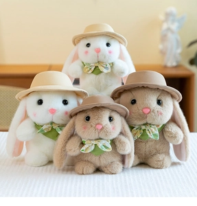 Close-up of cute plush rabbits wearing sun hats and floral ties in warm home setting
