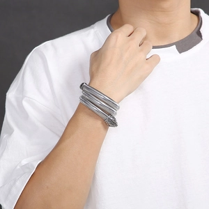 Detail of silver snake wrap bracelet in 304 stainless steel on a model's wrist