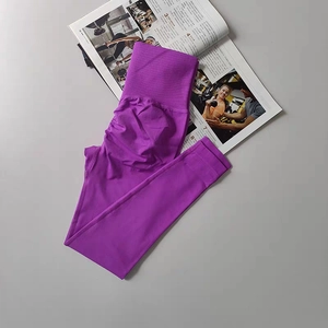Detail view of high waist ribbed waistband and scrunch butt seam on purple yoga pants