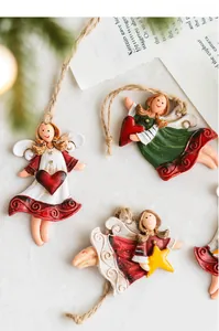 Close-up of three vintage resin angel ornaments with twine hangers for Christmas tree decor