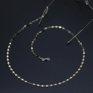 Detailed view of gold star-shaped chain links with silicone loops for eyewear