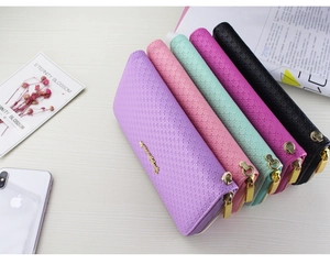 Detailed arrangement of long PU leather zip wallets with diamond texture and gold hardware