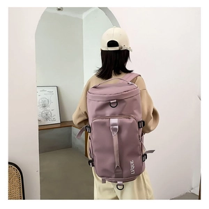 Detail of lavender lightweight cylinder travel backpack with side adjustable straps and D-ring