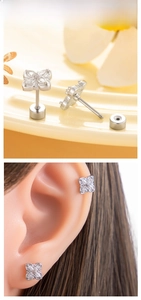 Detail of silver flower stud earring with white zircons and flat screw back design