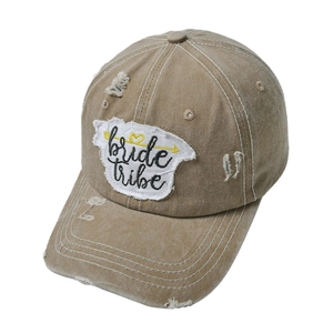 Detail of vintage washed khaki baseball cap with bride tribe embroidered patch