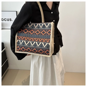 Detailed close-up of ethnic geometric pattern tote bag with jute woven handles