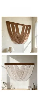 Detail of handmade macrame wall hanging with wooden bars and layered woven ropes