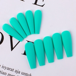 Macro detail of matte tiffany blue press on nails in long ballet shape on magazine base