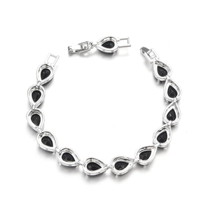 Detailed view of silver bracelet featuring black pear-cut stones and jewelry clasp