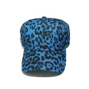 Close-up of blue leopard print baseball cap showing cotton twill fabric texture and seams