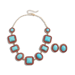 Bohemian retro gold jewelry set with turquoise stones and red rhinestones on white background