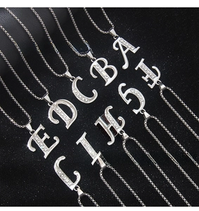 Detailed view of silver letter necklaces A to I with sparkling zircon stones inlays